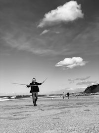 a man is flying a kite on the beach